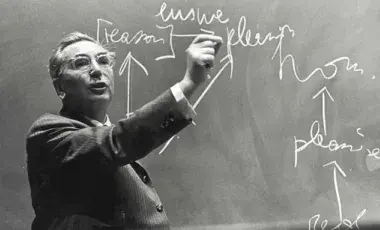 Frankl draws on chalkboard.