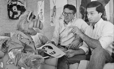 Writer and co-creator Tom Patchett, left, and voice actor Paul Fusco, right, are confronted with last-minute script changes from star ALF.