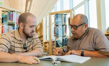 Male Tutor and male learner working together