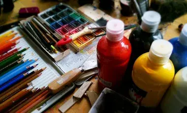 Various art supplies such as color pencils, watercolor, acrylic 