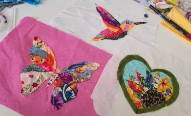 fabric scrap collage of a butterfly, bird, and heart 