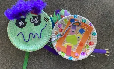 Handmade monster crafts made out of paper plates and assorted craft items