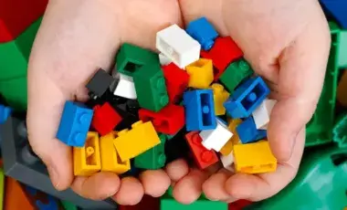 Cupped hands holding Legos