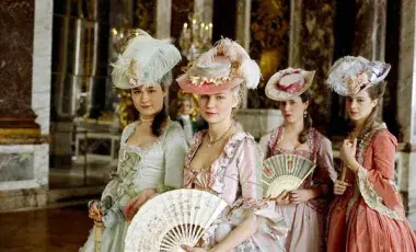 Four ladies dressed in beautiful, colorful French style dress