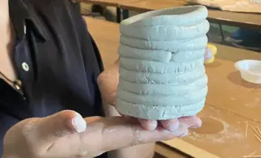 hands holding sculpture