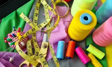 measuring tape, thread various colors, scissors, pins, pin cushion and fabric