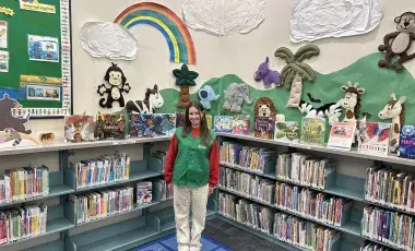 Star reader volunteer standing in the children's area.