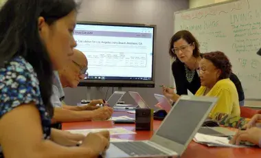Adult learners learning in a class room setting.