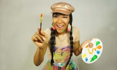 Snooknuk holding a paint palette and paintbrush