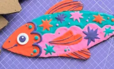 colorful clay fish on flat board