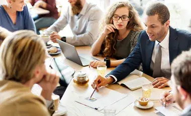 people gathered around a table having a financial discussion