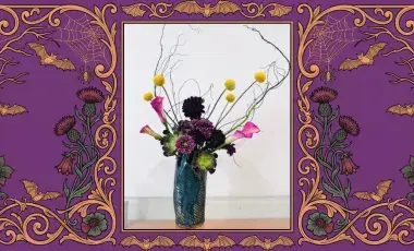 A spooky Japanese floral arrangement is displayed in the middle of a decorative spooky frame.