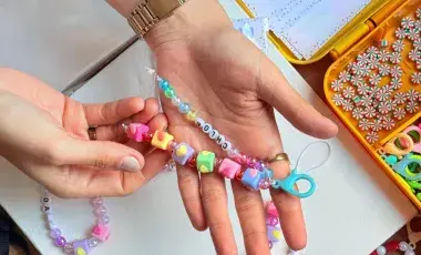 hand holding colorful bracelet beads