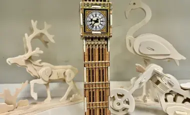 Image of a variety of 3D wooden puzzles (of animals, a building and a vehicle)