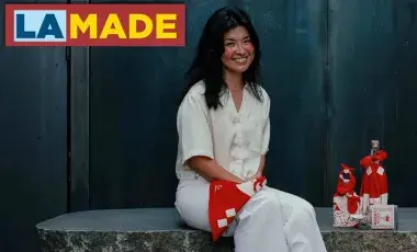 a person posing and smiling in front of a few wrapped items