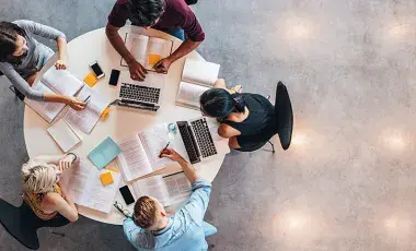 Four students are working on assignments together 