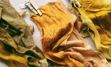 Three naturally dyed pieces of cloth of different shades. 