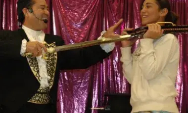illusionist Allen Oshiro and a volunteer as they perform a magic trick.