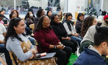 smiling women sitting in an audience