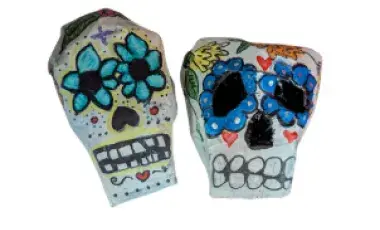 two paper mache skulls