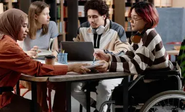 Four teens studying at a table