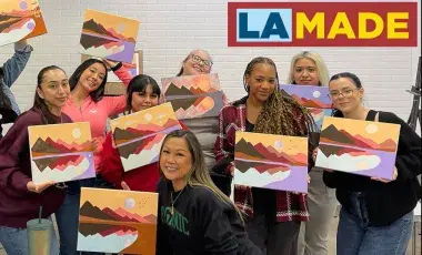 adults with paintings made in a class