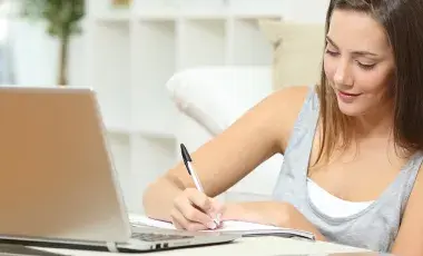 Woman writing on paper.