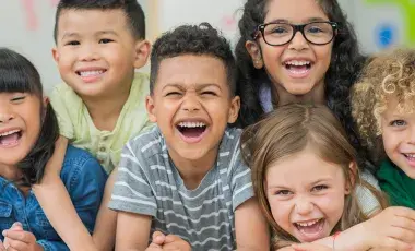 Six young children laughing.