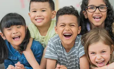 Six young children laughing.