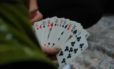 A person holding playing cards