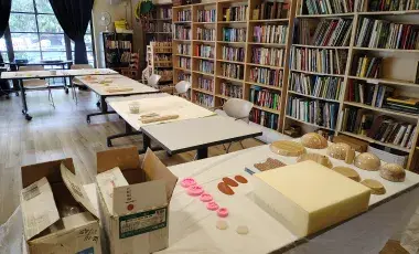 Setup for a ceramics program with clay and other ceramics tools on the tables 