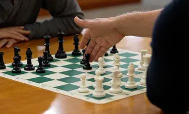 chess board with a hand pointing
