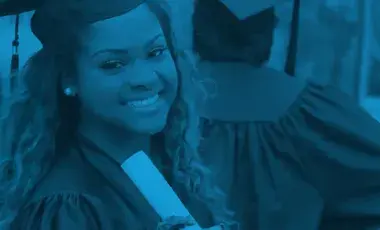 Teen graduate smiling in cap and gown.