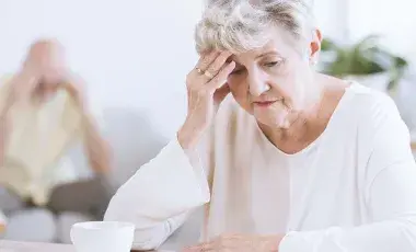  seniors looking down with head in hands