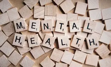 Scrabble game pieces spelling out "Mental Health"