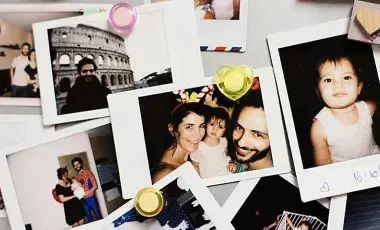 Collection of family pictures with small magnets in the corners.