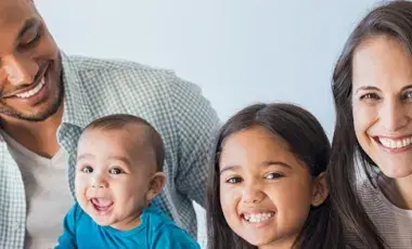 Mother, father and two children smiling