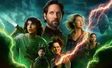 The cast of Ghostbusters afterlife pictured behind a field of lightning 