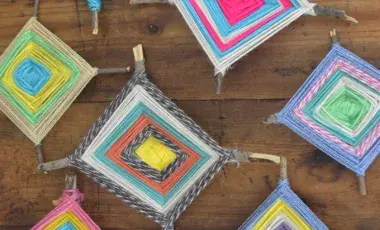 An assortment of completed Ojos de Dios in various colors. 