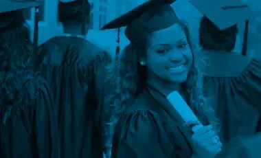 Graduates wearing caps and gowns, with one graduate holding a diploma.