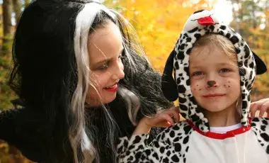 Halloween costumes, a witch and a spotted dog