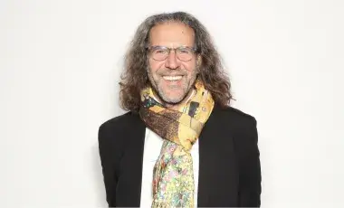 Ira Israel wearing a scarf and glasses.