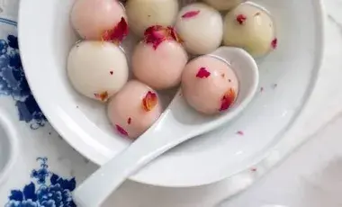 Colorful Tang Yuan, a Chinese dessert dumpling, in a white bowl