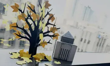 Paper skeleton tree against cityscape