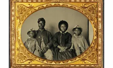 Quarter-Plate Ambrotype taken between 1863 and 1865. Image depicts a Black Union Army private and his wife and twin daughters.