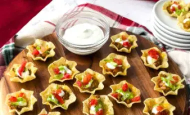 Mini Tacos on Wood Serving Tray with Sour Cream in a dish and plates