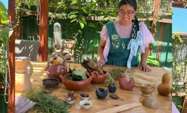 person with ceramic pots and plants