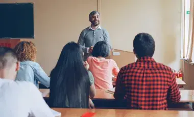 Adults in a classroom doing a lesson