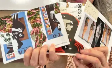 Woman holding three handmade zines.