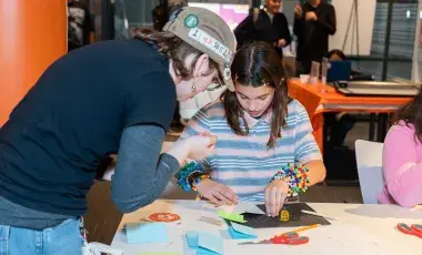 2 teens crafting at a library event